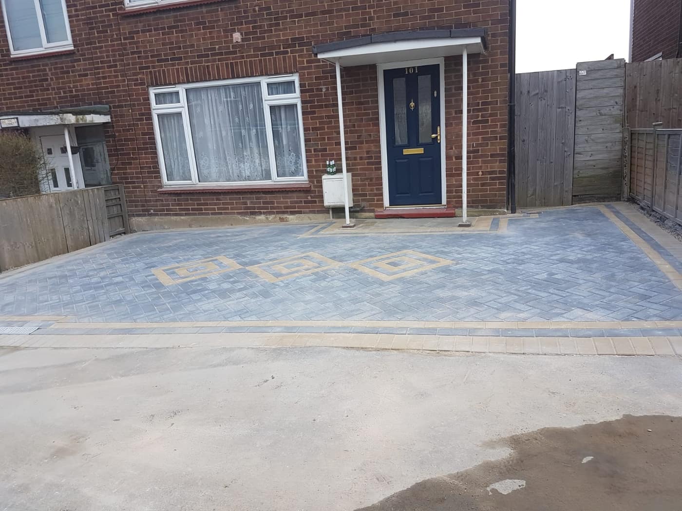 Block paved driveway with sleeper retaining walls