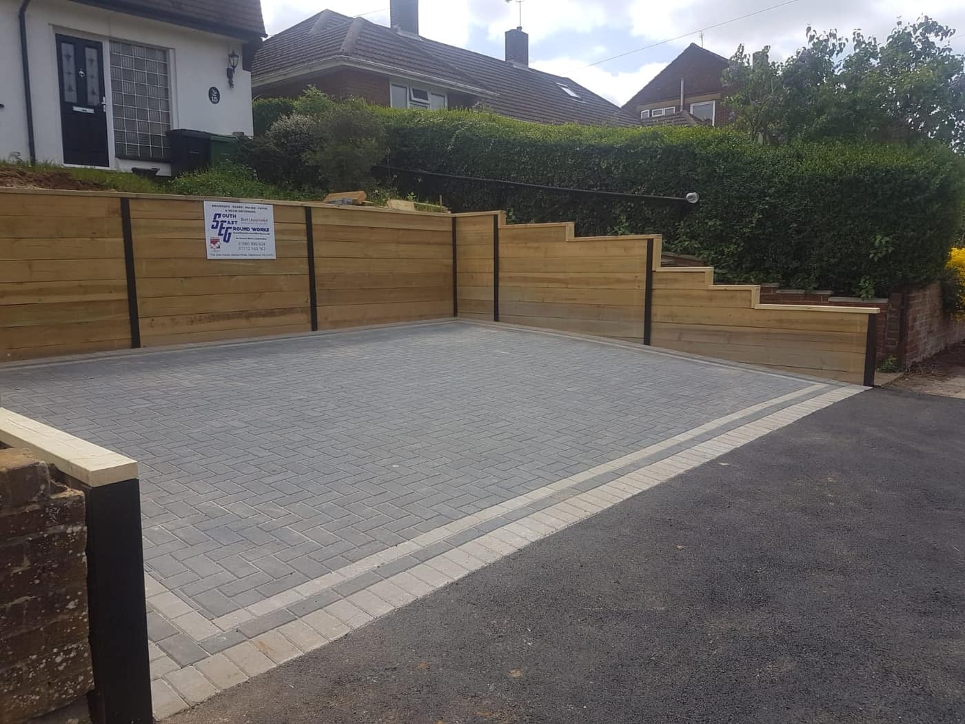 Block paved driveway with sleeper retaining walls